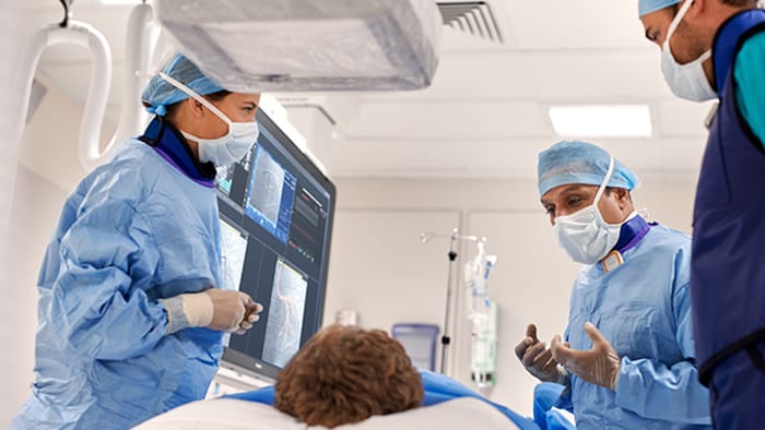 (opens in the same window) Interventional cardiologists looking at clinical images